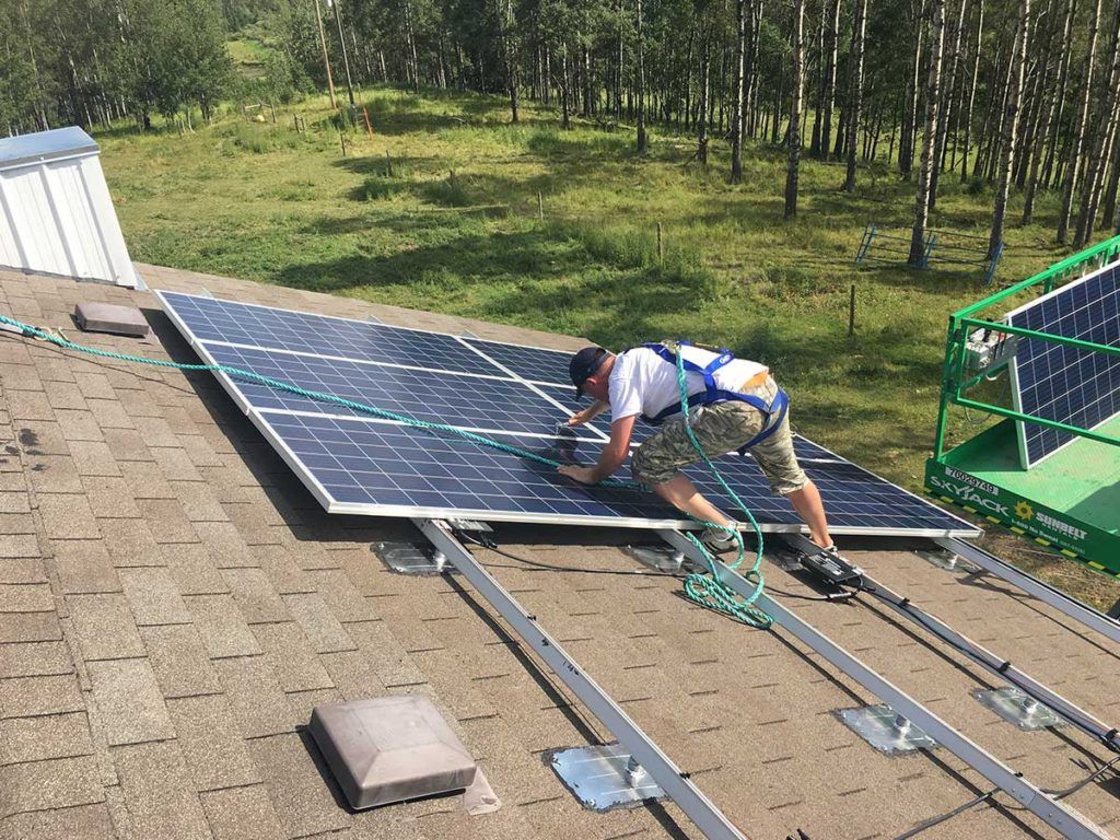 a man installing a solar panel on a residential roof