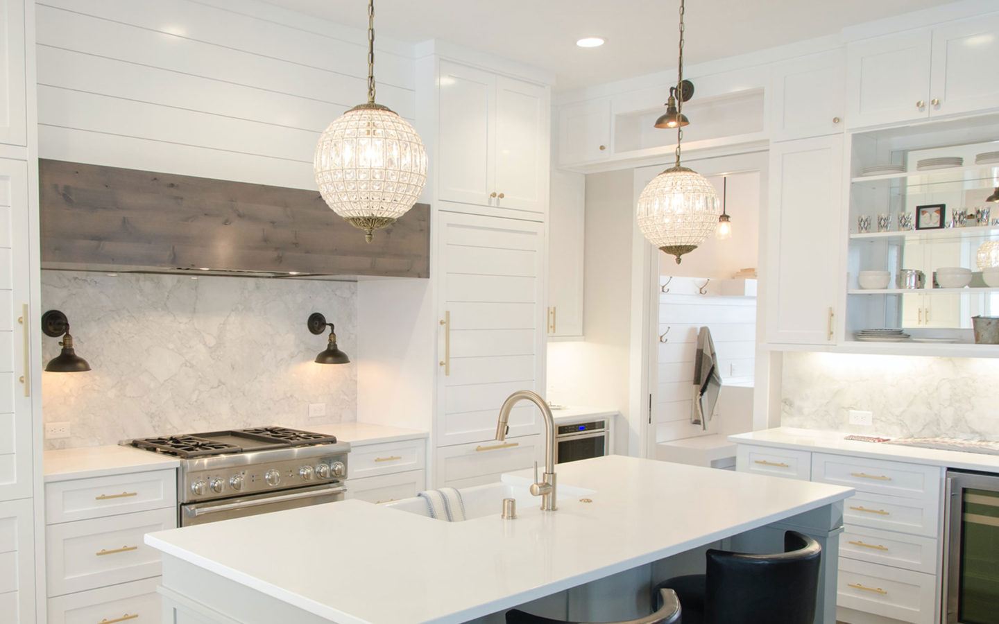 a white kitchen island with white countertops