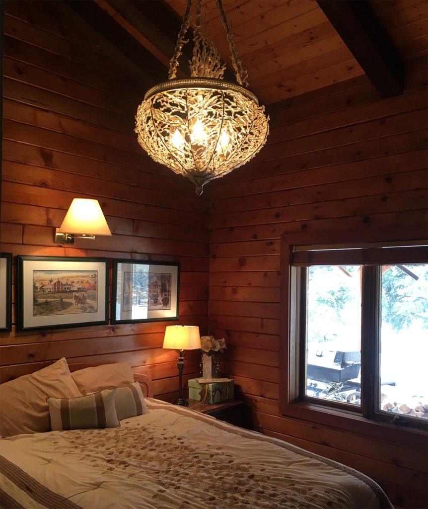 a bedroom with a double bed in a log cabin