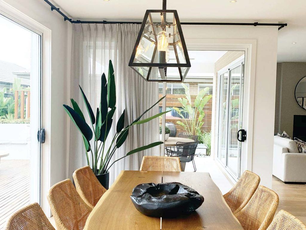 a wooden dining room table in a remodelled house