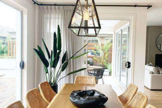 a wooden dining room table in a remodelled house