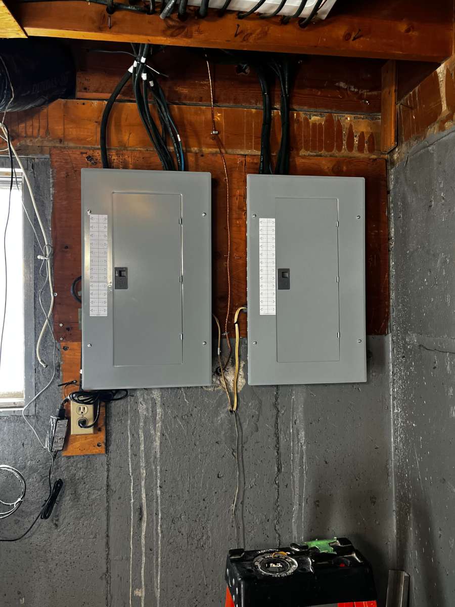 a couple of electrical boxes mounted to the side of a wall