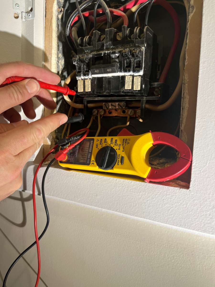 a person is working on an electrical panel