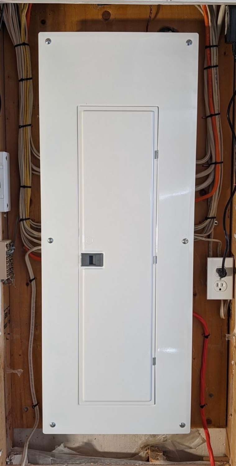 a white electrical 100 amp panel installed by a master electrician