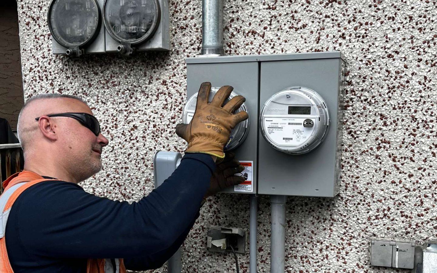 a man in a safety vest working on a meter