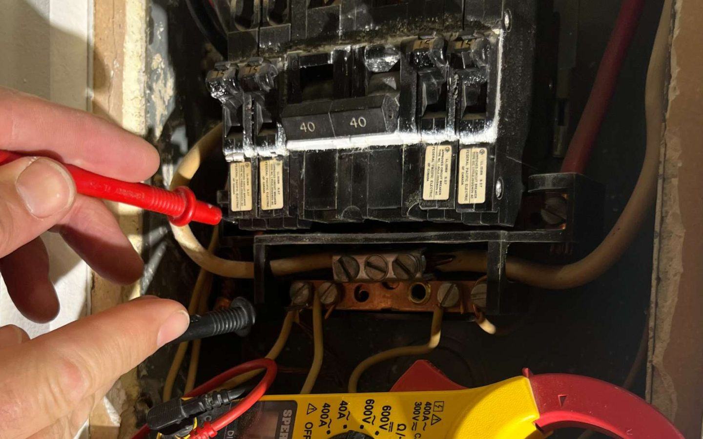 a person is working on an electrical panel